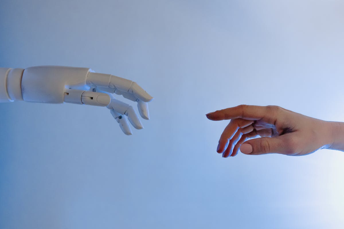 A human hand and a robot hand reaching toward each other — symbolizing the connection and trust between humanity and AI